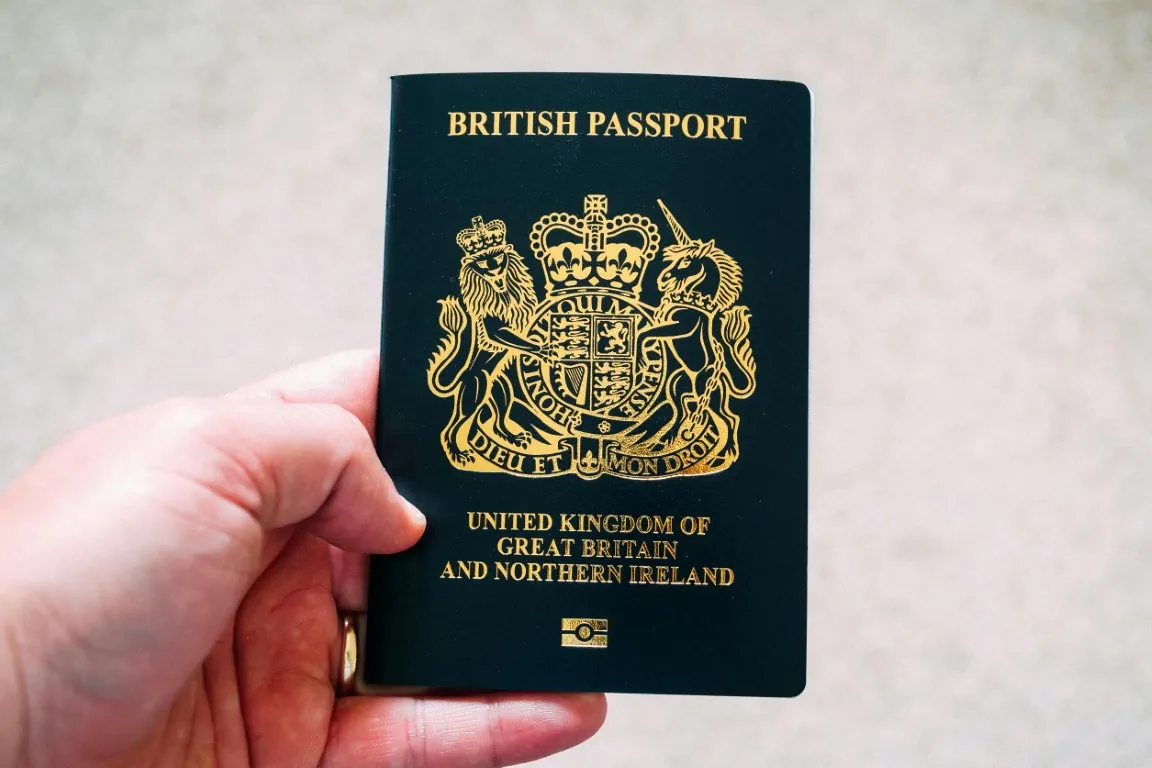Hand holding a British passport